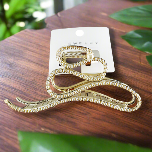 Gold hair clip studded with rhinestones