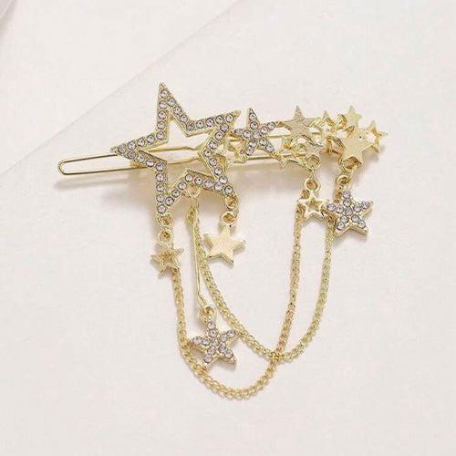 Gold hair accessory in the shape of stars with chains hanging from them