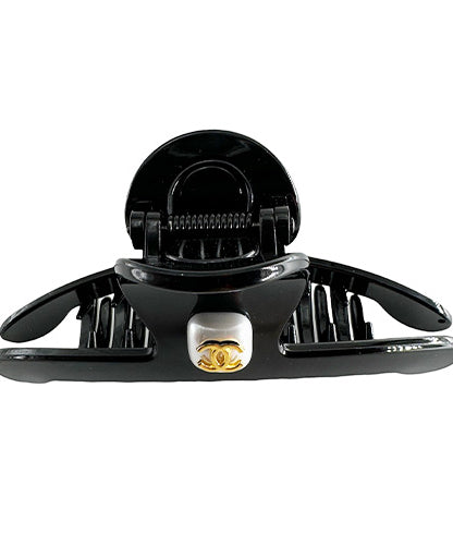 Hair Clip Black with a rhinestone center and the Chanel symbol