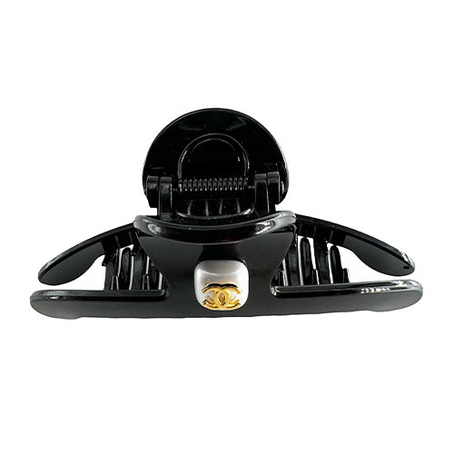 Hair Clip Black with a rhinestone center and the Chanel symbol
