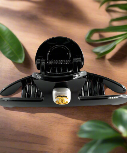 Hair Clip Black with a rhinestone center and the Chanel symbol