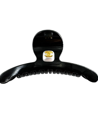 Hair Clip Black with a rhinestone center and the Chanel symbol