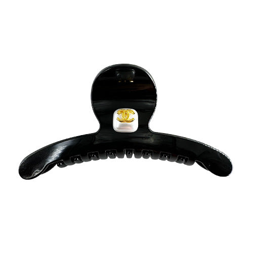 Hair Clip Black with a rhinestone center and the Chanel symbol