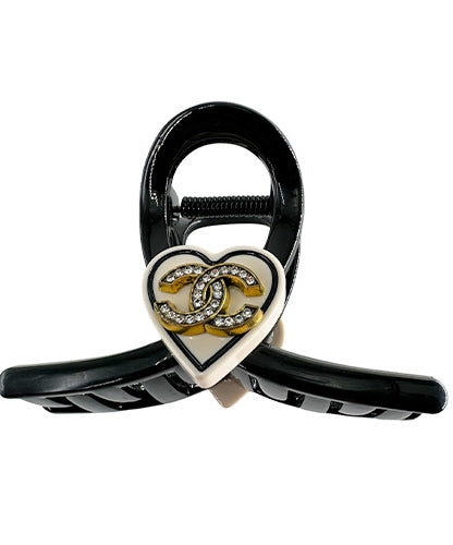 Hair Clip Black with a beige heart in the middle containing the Chanel symbol