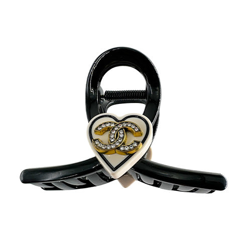 Hair Clip Black with a beige heart in the middle containing the Chanel symbol