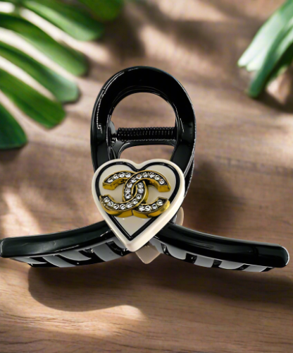 Hair Clip Black with a beige heart in the middle containing the Chanel symbol
