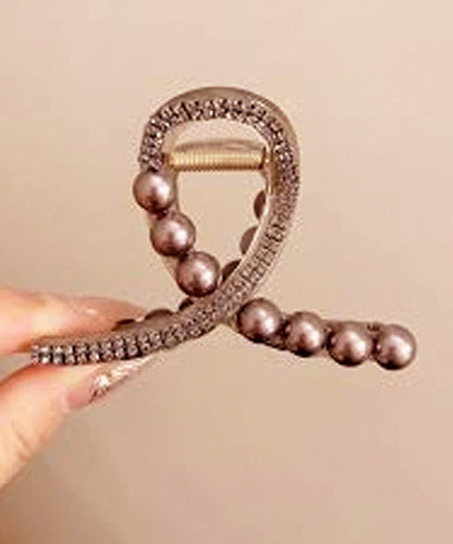 Brown hair clip studded with beads Brown hair clip studded with beads