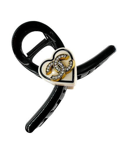 Hair Clip Black with a beige heart in the middle containing the Chanel symbol