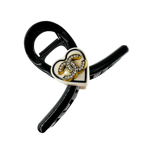 Hair Clip Black with a beige heart in the middle containing the Chanel symbol